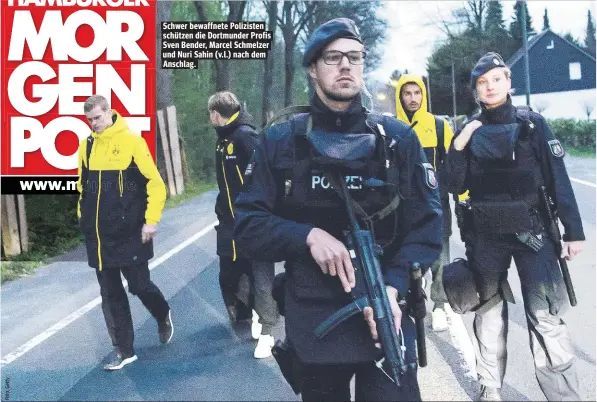  ??  ?? Schwer bewaffnete Polizisten schützen die Dortmunder Profis Sven Bender, Marcel Schmelzer und Nuri Sahin (v.l.) nach dem Anschlag.