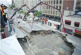  ?? ASHLEY FRASER ?? June 9 On Day 2, boom concrete pumps are used to fill the large sinkhole on Rideau Street.