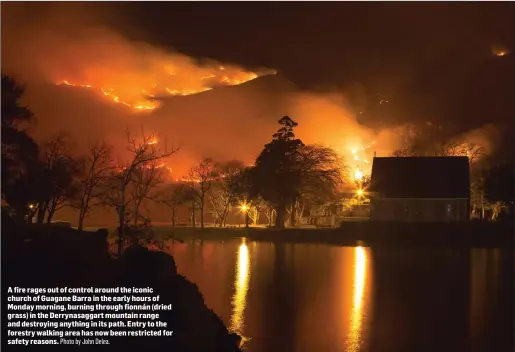  ?? Photo by John Delea. ?? A fire rages out of control around the iconic church of Guagane Barra in the early hours of Monday morning, burning through fionnán (dried grass) in the Derrynasag­gart mountain range and destroying anything in its path. Entry to the forestry walking...