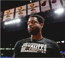  ?? Miami Heraldl/tns ?? The Miami Heat’s Dwyane Wade listens to the national anthem before the start of a game against the Oklahoma City Thunder at American Airlines Arena in Miami on Feb. 1.