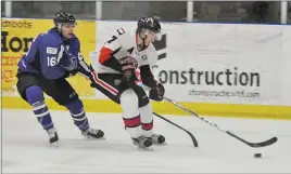  ?? CAROL DUNN/THE NEWS ?? Mack Derraugh carries the puck with Amherst Ramblers forward Felix Leblanc in pursuit on Monday at the Pictou County Wellness Centre.