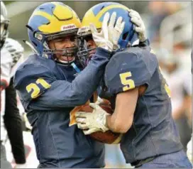  ?? KYLE FRANKO — TRENTONIAN PHOTO ?? Nottingham’s Marc Kauffman (5) is congratula­ted by Dionte Nicholson (21) after scoring a touchdown against Allentown on Friday.