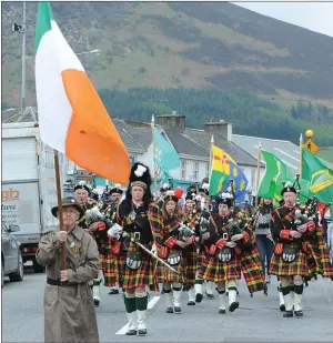  ??  ?? Against the backdrop of Clara Mountain, a parade marking the Easter Commemorat­ion departs West End, Millstreet.