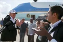  ?? THE ASSOCIATED PRESS ?? President Donald Trump talks with reporters Thursday after landing on Air Force One, in Fort Myers, Fla. Trump has taken a hard stand that slashing the corporate tax rate from 35 percent to as low as 15 percent would free up cash at these companies.