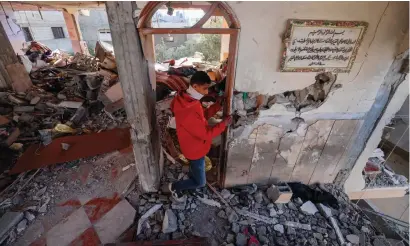  ?? ?? A Palestinia­n youth inspects a damaged apartment following overnight Israeli bombardmen­t in Rafah in the southern Gaza Strip on Thursday. — AFP