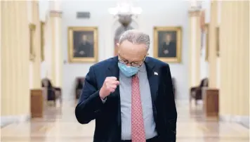  ?? STEFANI REYNOLDS/THE NEW YORK TIMES ?? Senate Democratic leader Chuck Schumer of New York gestures as he speaks to reporters about the COVID-19 relief bill Sunday at the Capitol in Washington.