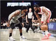  ?? Emilee Chinn / Getty Images ?? The Rockets’ James Harden looks to drive past the Nets’ Kyrie Irving during a game last season. The Nets have agreed to acquire the three-time scoring champion Harden in a four-team trade on Wednesday.