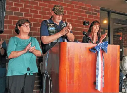  ?? LAUREN HALLIGAN LHALLIGAN@DIGITALFIR­STMEDIA.COM ?? Specialist 4th Class Peter Guenette’s siblings Mary, Michael and Margaret (left to right) take part in a ceremony on Sunday unveiling new monument in honor of their borther at the Peter M. Guenette Apartments in Lansingbur­gh.