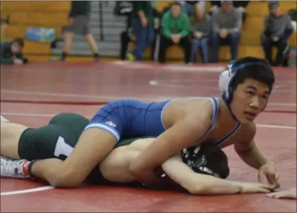  ?? ALEX WAHL/FOR DIGITAL FIRST MEDIA ?? North Penn’s Eddie Galang goes for pin against Methacton Saturday.