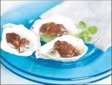  ??  ?? This April 7, 2014 photo shows grilled oysters with fermented black beans and chili garlic in Concord, N.H. This recipe was inspired by chefs at the South
Beach Food Festival in Miami Beach, Fla. (AP)