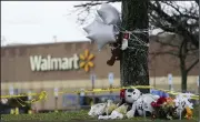  ?? (AP/Carolyn Kaster) ?? A makeshift memorial is seen in the parking lot of the Walmart Supercente­r in Chesapeake, Va. on Sunday. Six people were killed when a manager opened fire at the store with a handgun on Tuesday.