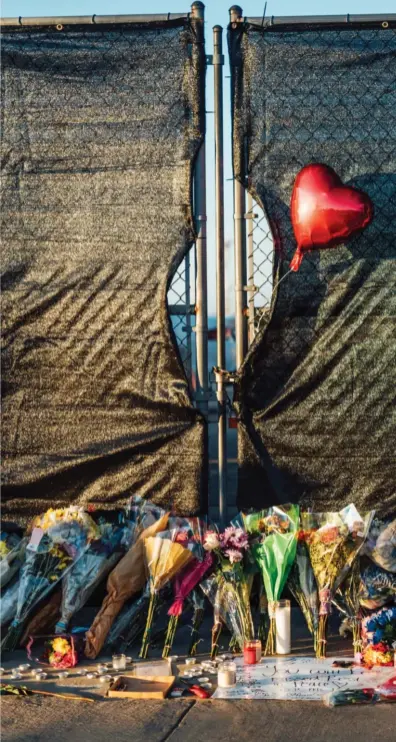  ?? ?? An impromptu memorial lined with flowers, photos, and candles outside of NRG Park