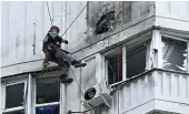  ?? AFP ?? A specialist assess the damage on a multi-story building after a drone attack in Moscow on Tuesday.