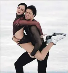  ?? JAMES HILL THE NEW YORK TIMES ?? In a performanc­e by turns athletic, sensual and expressive, Virtue and Moir reclaimed the Olympic gold medal.