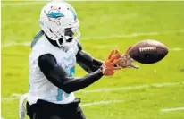  ?? TAIMY ALVAREZ/SUN SENTINEL ?? Dolphins receiver Jakeem Grant catches a pass Tuesday during organized team activities in Davie.