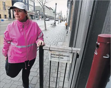  ?? CLIFFORD SKARSTEDT/EXAMINER ?? Local resident and former nurse Gwen Eccleston stretches on Tuesday near the Running Room on Hunter St. Eccleston went from being a 20-year smoker to leading the Walk or Run to Quit program.