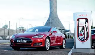  ??  ?? Powering
up: Tesla’s Supercharg­er can deliver 170 miles of range in 30 minutes.