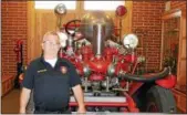  ?? TAWANA ROBERTS — THE NEWSHERALD ?? Frank Whittaker stands near an old fire truck at the fire station.