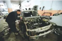  ??  ?? WORKER fixes a car at an industrial neighborho­od of Mosul, Iraq, Jan. 31.