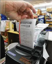  ?? MARSHALL GORBY / STAFF ?? Local ticket-selling businesses such as Bee-Gee’s Minit Market in Kettering said Thursday buying has been brisk forMegaMil­lions and Powerball.