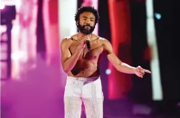  ?? JOHN SALANGSANG ?? Childish Gambino is nominated for multiple Grammy Awards for his highly political protest song This is America. The powerful video for the song adds important layers of context to the lyrics.