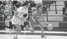  ?? JOHN MCCALL/SOUTH FLORIDA SUN SENTINEL ?? South Broward’s Fabiana Poindujour drives the ball against Western’s Riley Stoker during the first half of a girls basketball regional semifinal on Tuesday in Davie.