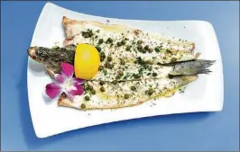  ?? PHOTO BY BROOKE HALL ?? Ouzo Bay’s branzino is simply prepared and served with some flair.