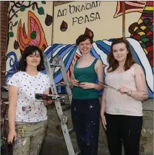  ??  ?? Caroline Mc Evoy , Maia Mc Veigh and Hannah Horan painting murals for the Fleadh at the North Strand.