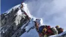  ??  ?? A photo that went around the world in 2019: A backlog of climbers aiming to conquer Everest