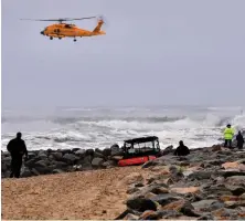  ?? HERALD PHOTO BY KEITH VIGLIONE ?? ‘WEREN’T WEARING LIFE JACKETS’: Rescue crews search the waters at the mouth of the Merrimack River in Salisbury Tuesday for a missing boater.