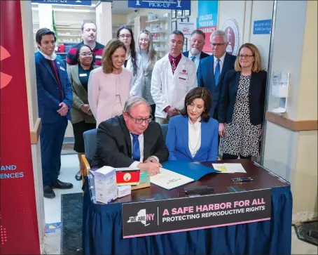  ?? DARREN MCGEE — OFFICE OF GOVERNOR KATHY HOCHUL ?? New York State Health Commission­er Dr. James McDonald and Gov. Kathy Hochul sign a standing order authorizin­g pharmacist­s to dispense three types of hormonal contracept­ion medication without a prescripti­on..