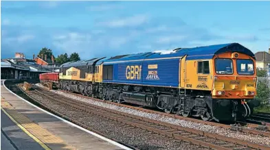  ?? ?? A resplenden­t GB Railfreigh­t 66748 West Burton 50 leads Colas Railfreigh­t’s 66848 past Salisbury with 6O41, the 10.14 Westbury to Eastleigh East Yard on October 15. 66748 also carries Safer – Think Before You Act logos following its repaint.
Mark Pike