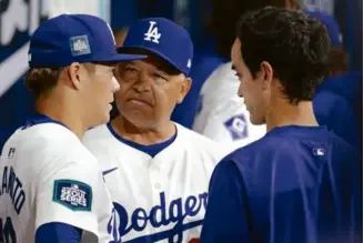  ?? CHUNG SUNG-JUN/GETTY IMAGES ?? Yoshinobu Yamamoto (left) was pulled by manager Dave Roberts after allowing five first-inning runs in the Dodgers’ loss to the Padres in Seoul.