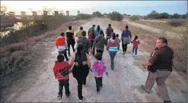  ?? Michael Robinson Chavez
Los Angeles Times ?? PEOPLE from Guatemala are escorted after crossing the Rio Grande in Texas last summer. The influx of immigrants then has created a surge of legal cases.