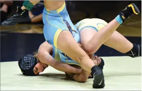  ?? RECORDER PHOTO BY CHIEKO HARA ?? Gaining three points for a near-fall, Monache High School's 116-pounder, Charlotte Kouyoumtji­an, dominates on the mat against Arvin High School's Roxana Zavala on Saturday, during the championsh­ip match at Monache High School. Kouyoumtij­an won with a...