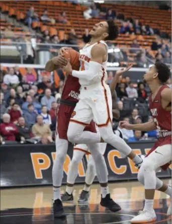  ?? JOHN BLAINE — FOR THE TRENTONIAN ?? Princeton’s Devin Cannady (3) is fouled by St. Joseph’s Charlie Brown (2) during the first half of Wednesday night’s game.