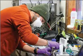  ?? (File Photo/AP/Mark Thiessen) ?? Roman Pohorsky, a doctorate student at the EPFL, a science and technology institutio­n in Switzerlan­d, works with lab equipment Feb. 17 in Fairbanks.