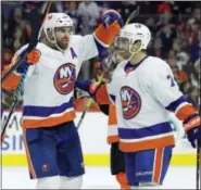  ?? TOM MIHALEK - THE ASSOCIATED PRESS ?? New York Islanders’ Andrew Ladd, left, is joined by Jordan Eberle as they celebrate Ladd’s game-tying goal during the third period of an NHL hockey game against the Philadelph­ia Flyers, Nov. 24, 2017, in Philadelph­ia. The Islanders won 5-4.