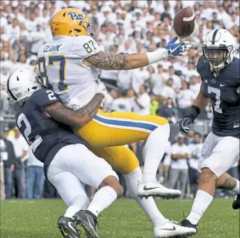  ?? Matt Freed/Post-Gazette ?? Pitt's Chris Clark can't pull in the ball as he's defended by Penn State's Marcus Allen in the Nittany Lions’ 33-14 win Sept. 9 at Beaver Stadium.