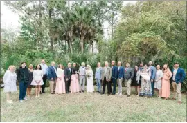  ?? PHOTOS COURTESY OF MADDY GODT ?? Elaine Hall and Roland Passaro are surrounded by family at their wedding ceremony in Palm Coast, Fla., this month.