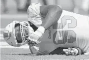  ?? JOE CAVARETTA/SUN SENTINEL ?? Defensive end William Hayes injured himself trying to avoid a roughing the passer penalty on Sunday against Oakland.