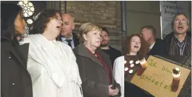  ?? (Christian Mang/Reuters) ?? GERMAN CHANCELLOR Angela Merkel attends a gathering yesterday at the New Synagogue in Berlin. Inset: Candles are placed along a sign reading, ‘I am horrified’ at the scene of the attack in Halle.