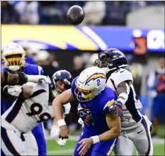  ?? ?? Broncos cornerback Ja’quan Mcmillian swats the ball away from Chargers quarterbac­k Easton Stick in the second quarter, picked it up and ran into the end zone, but the play was called back and ruled an incomplete forward pass on Sunday at Sofi Stadium in Inglewood, Calif.