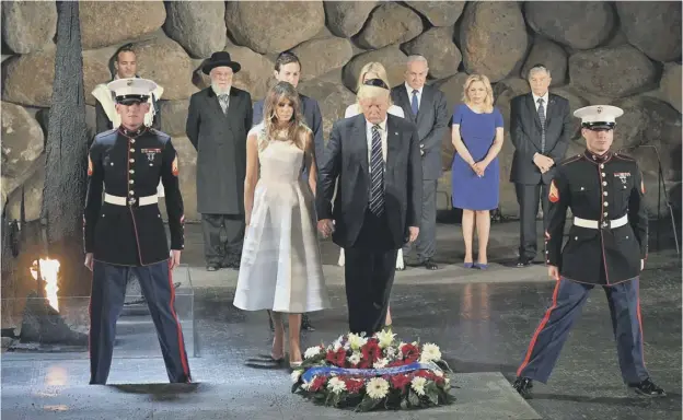  ??  ?? 0 Donald and Melania Trump lay a wreath during a visit to the Yad Vashem Holocaust Memorial museum, commemorat­ing the six million Jews killed by the Nazis