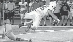  ?? ANTRANIK TAVITIAN/THE REPUBLIC ?? St. Mary’s ball carrier David Galindo jumps over a tackle during a game against Glendale Union on Oct. 29 in Glendale.