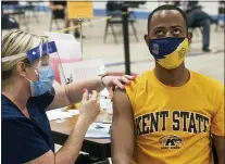  ?? PHIL LONG — THE ASSOCIATED PRESS ?? Kent State University student Marz Anderson gets his Johnson & Johnson COVID-19vaccinat­ion from university nurse Beth Krul in Kent, Ohio, on Thursday. U.S. colleges are weighing how far they should go in urging students to get the COVID-19 vaccine.