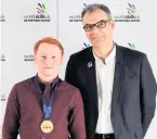  ??  ?? Recognitio­n Thomas Scott brought home a gold award (pictured with Toby Bell)