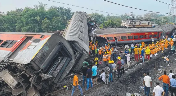  ?? Picture: AFP ?? Rescue workers scoured the crash scene for survivors of the accident.