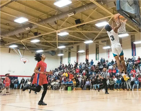  ?? BILLY SCHUERMAN/STAFF ?? Woodside’s Mykel Jenkins dunks the ball against Princess Anne during a Class 5 state quarterfin­al Friday night at Denbigh High in Newport News. Jenkins led the Wolverines with 21 points.