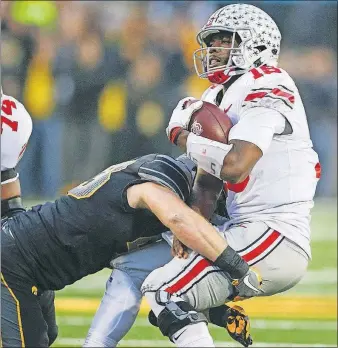  ?? [JOSHUA A. BICKEL/DISPATCH] ?? Ohio State quarterbac­k J.T. Barrett is tackled during the 55-24 loss at Iowa on Saturday. Barrett said he’s trying to learn from the defeat and prepare for this week’s game against Michigan State.